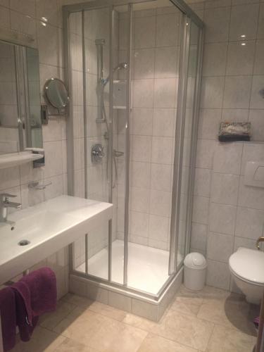 a bathroom with a shower and a sink and a toilet at Sportpension Rubin in Sölden