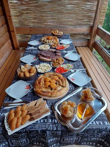 a table topped with lots of different types of food at Koliba Pčelica 1-SPA in Bijelo Polje