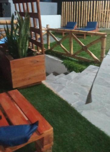 a patio with two chairs and a potted plant at Tranquilidad y Sol in Cieneguilla
