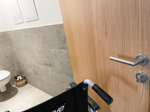 a close up of a bathroom door with a vacuum at Wasserfall Apartments Mellau in Mellau