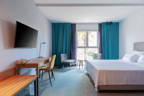 a hotel room with a bed and a desk and a window at Boutique hotel Lili in Rovinj