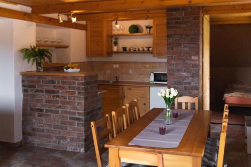 a kitchen and dining room with a table and chairs at Chalupa Bišík in Teplice nad Metují
