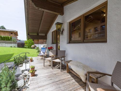 a patio with chairs and tables on a house at Eden Appartements in Going