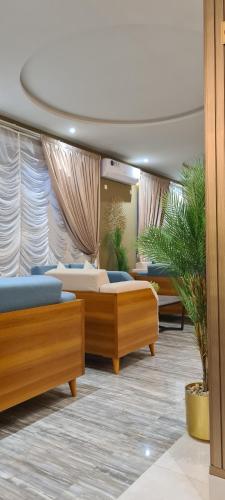 a bedroom with two beds in a room with curtains at شقق لمسات الخير الخيالة للشقق المخدومةAh in Riyadh