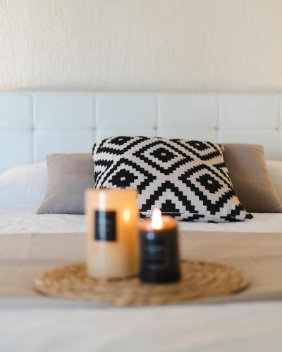 a candle on a table in a room with a bed at Residence Poseidon in Spartia
