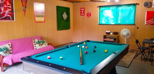 a living room with a pool table with balls on it at Cedar Ridge Retreat Lake Almanor in Lake Almanor