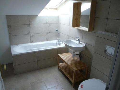 a bathroom with a sink and a tub and a toilet at La Mare aux oiseaux 1608 in Sassenage