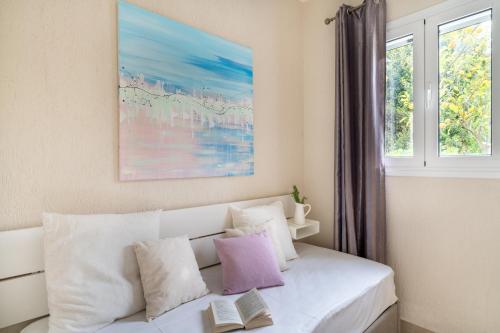 a white couch in a room with a window at Residence Poseidon in Spartia