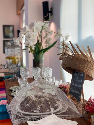a table topped with a plate of brownies and flowers at Hotel Porto Real Aparecida in Aparecida