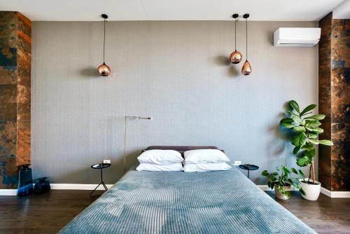 a bedroom with a large bed with two pillows at Odesa Pearl Apartments in Odesa