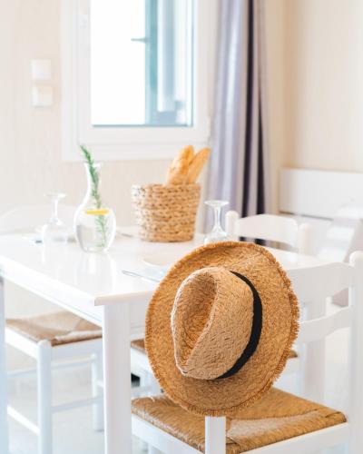 a straw hat sitting on a white dining room table at Residence Poseidon in Spartia