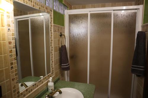 a bathroom with a shower and a sink and a mirror at LA COVETA - Aptos. Vilapart in Vilafamés