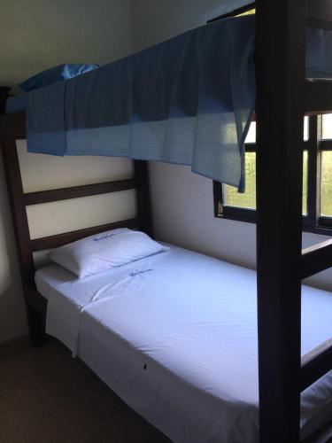 two bunk beds in a room next to a window at Desiderata Resort in Guaduas