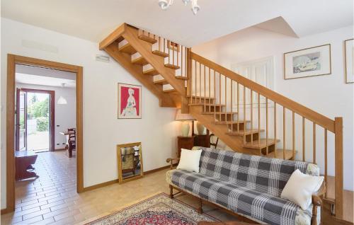 a living room with a staircase and a couch at 2 Bedroom Gorgeous Home In Montemerlo in Villa Marin