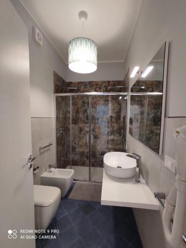 a bathroom with two sinks and a toilet and a shower at San Pietro Otranto in Otranto