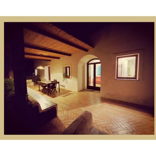 a living room with a table and a bench in a house at Birbiciù mare in Pantelleria