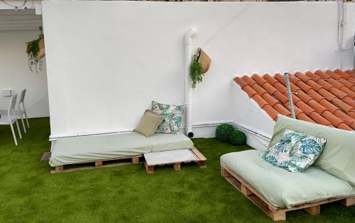 a living room with a couch and a chair at Estudio Garzolini in San José