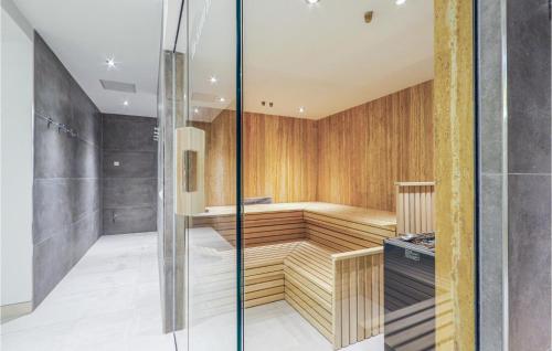 a sauna with wood paneling and a glass wall at Prora Solitaire Panorama 04 in Binz