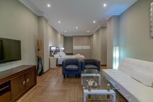 a living room with a couch and a bed at Hotel Monasterio Granada - Adults Only in Granada