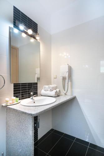 a bathroom with a sink and a mirror at Residence Poseidon in Spartia