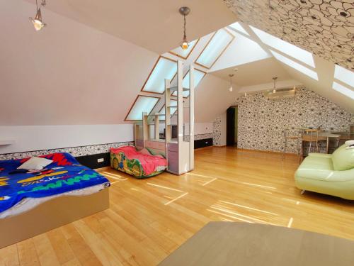 an attic bedroom with a bed and a chair at Приватний котедж з Басейном біля моря Совіньон Одеса in Odesa
