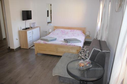 a small room with a bed and a table at Studio Apartments Adian in Korenica