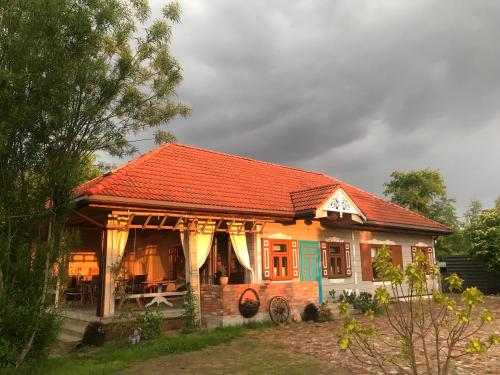 a small house with an orange roof at Zagroda w Puszczy in Białowieża