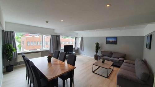 a living room with a table and a couch at Bremanger Fjord Hotell in Svelgen
