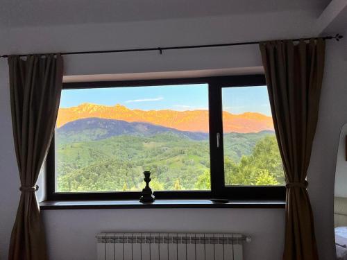 a window with a view of a mountain view at Belvedere Resort Moieciu in Moieciu de Jos