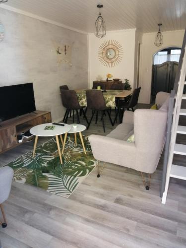 a living room with a couch and chairs and a table at The Violet House in Costa Nova