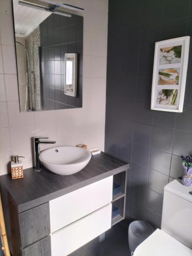 a bathroom with a sink and a mirror at The Violet House in Costa Nova