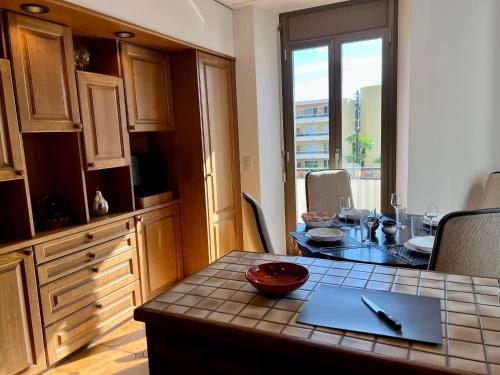 a kitchen with a table and a dining room at Tripolitania in Minusio