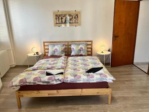 a bedroom with a bed with two tables at Tripolitania in Minusio