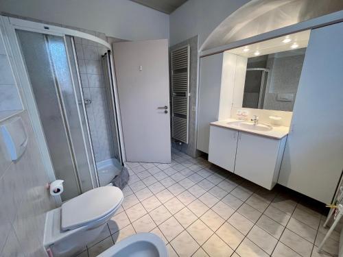 a bathroom with a toilet and a sink and a mirror at Tripolitania in Minusio