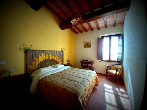 - une chambre avec un grand lit et une fenêtre dans l'établissement Agriturismo Podere Padolecchie - Azienda Agricola Passerini, à Torrita di Siena