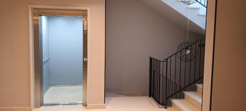 a hallway with a glass door leading to a staircase at Luxury apartment Stefanija in Tivat