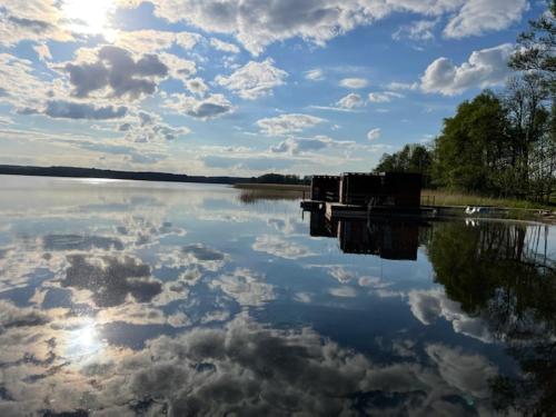 a large body of water with clouds in the sky at "B" Domki na wodzie Barczewko 2 z 4 domków in Barczewko
