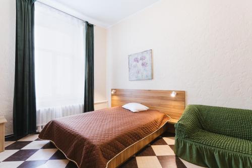 a bedroom with a bed and a chair and a window at Mini hotel Non-Stop in Kyiv