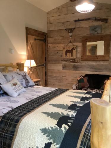 een slaapkamer met een bed met een houten muur bij Oak ridge cabin in Norwich