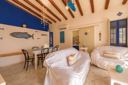a living room with a table and a couch at Dimore di mare - Beachfront Apartments in Santa Flavia