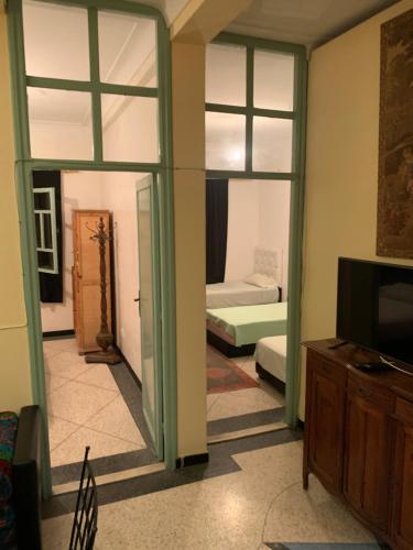 a room with a living room with a television and a room with a bed at Dar el Koutoubia in Marrakech