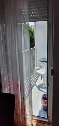 a sliding glass door to a balcony with a table at Apartman Luna in Valjevo