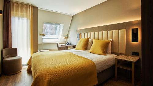 Postel nebo postele na pokoji v ubytování Hotel Hoogeveen