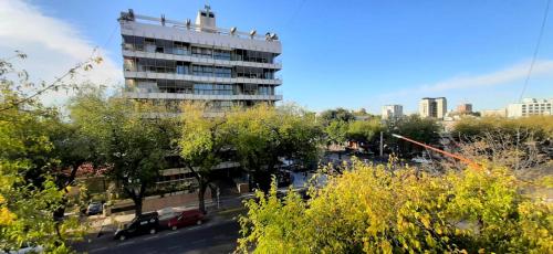 a tall building with cars parked in front of it at Emilio Civit in Mendoza