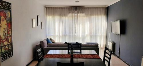 a living room with a couch and a table at Emilio Civit in Mendoza