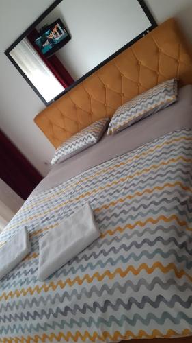 a bed with two pillows on top of it at Apartman Luna in Valjevo