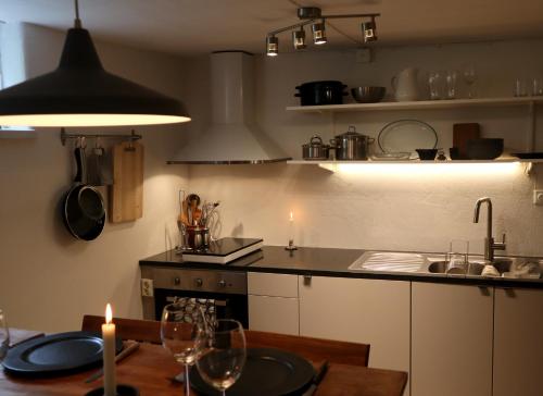 a kitchen with a table and a counter top with candles at Apartment with Terrace in the Swedish High Coast in Docksta