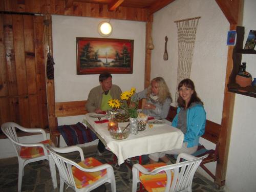 a group of people sitting at a table at Lile Pestani Accommodation in Peštani