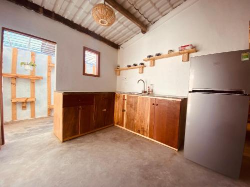 a kitchen with a refrigerator and a sink at Bluesea Homestay in Phu Yen