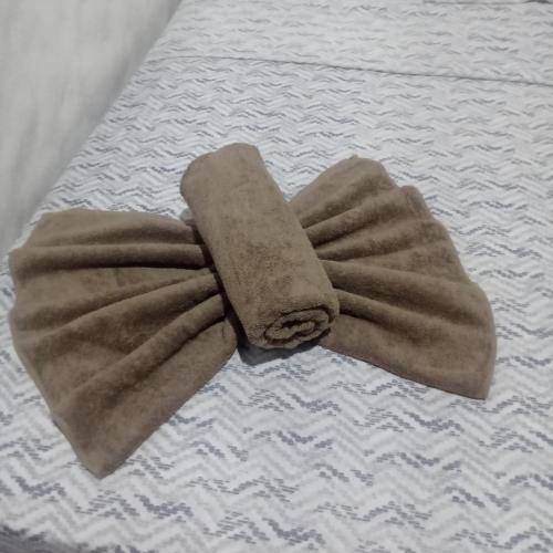 a brown towel laying on top of a bed at Ocean View in Puntarenas